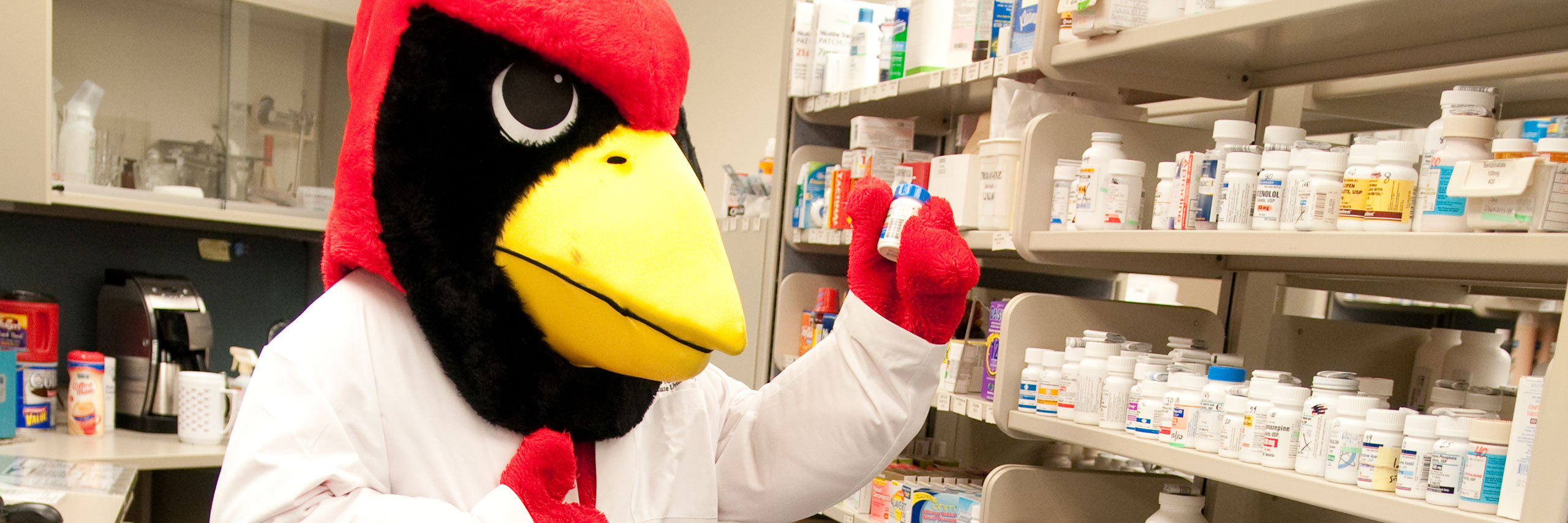 Reggie holding a medicine at the ISU pharmacy.