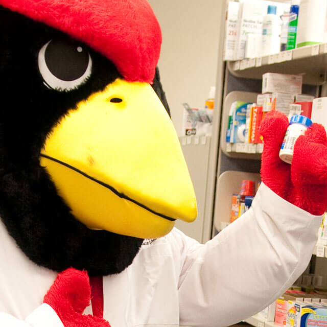 Reggie holding a medicine at the ISU pharmacy.